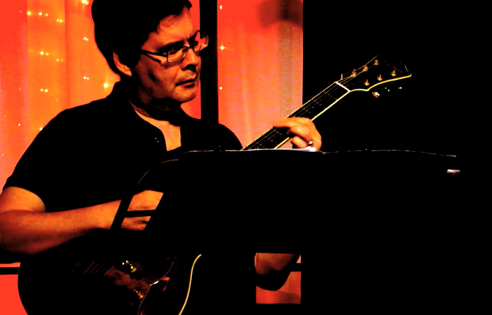 Reg plays guitar